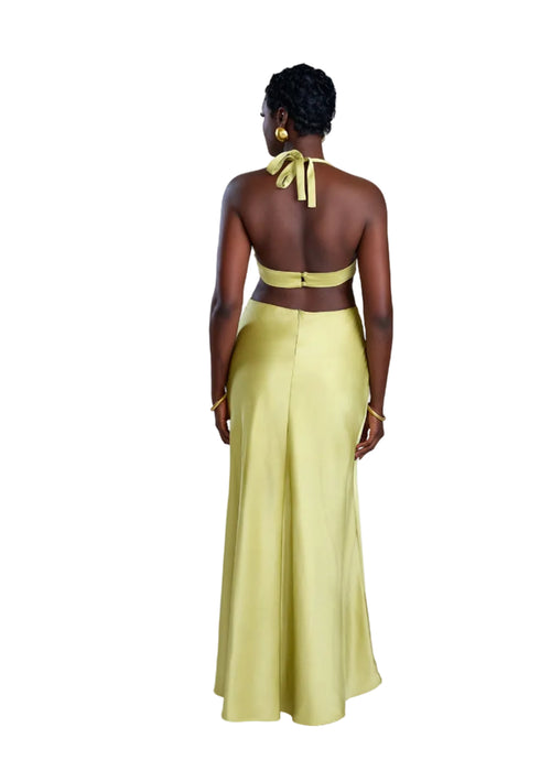 Woman wearing a yellow dress with a halter neck design on a white background