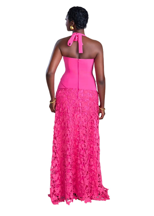 Woman wearing a pink lace dress with a white background