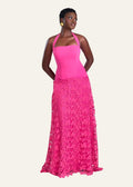 Woman wearing a pink dress with a floral skirt on a white background