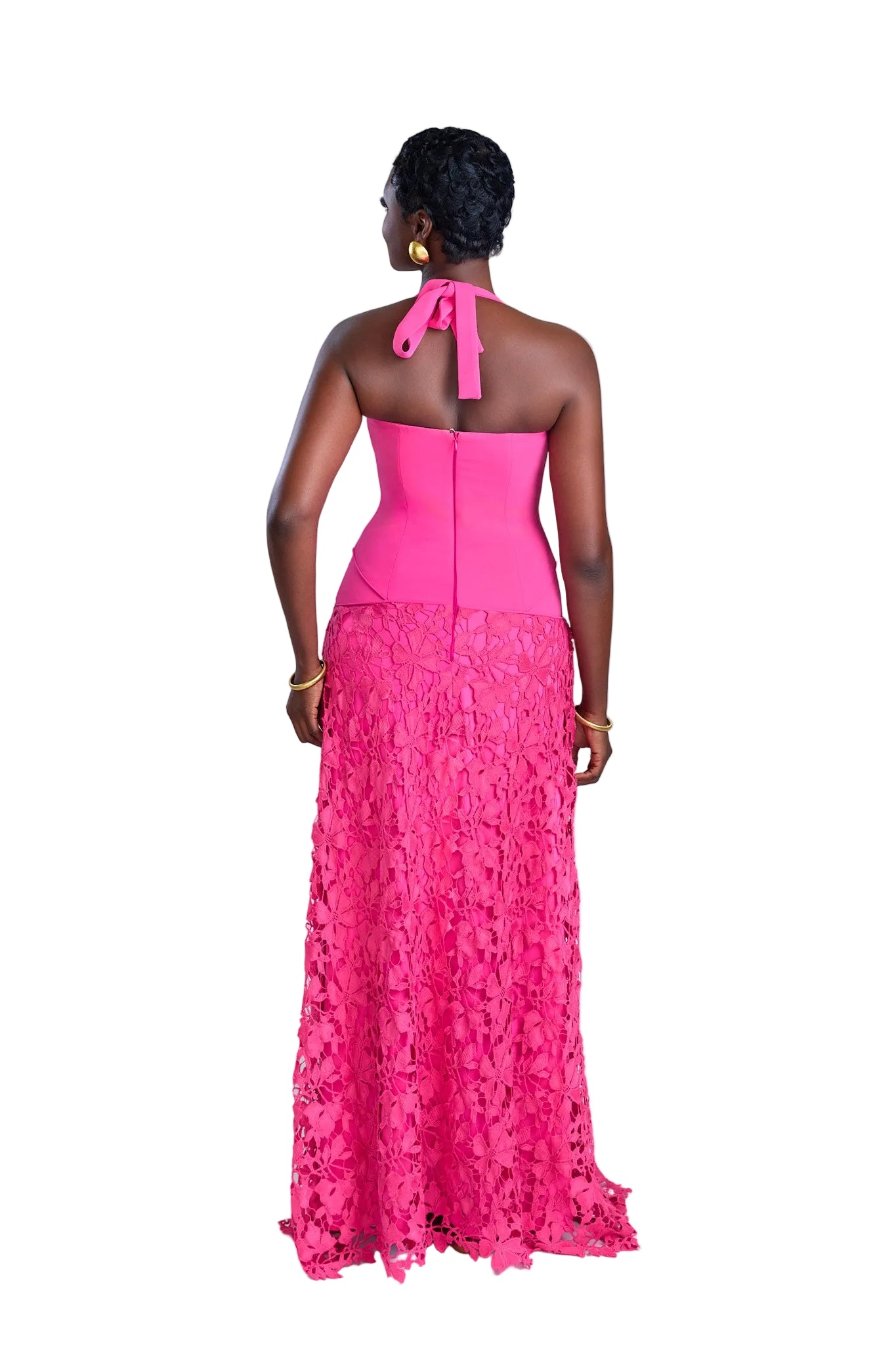 Woman wearing a pink lace dress with a white background