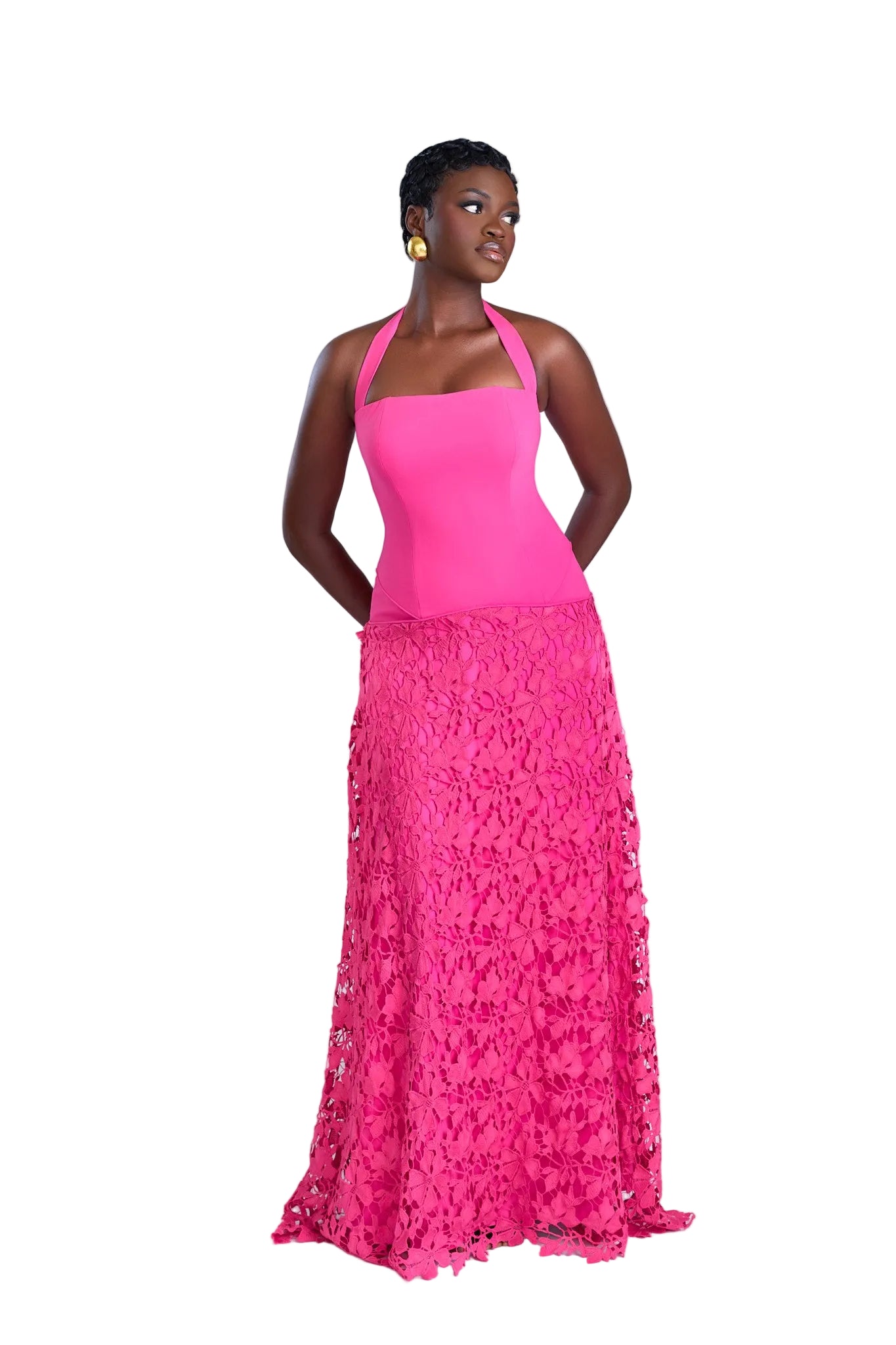 Woman wearing a pink dress with a floral skirt on a white background