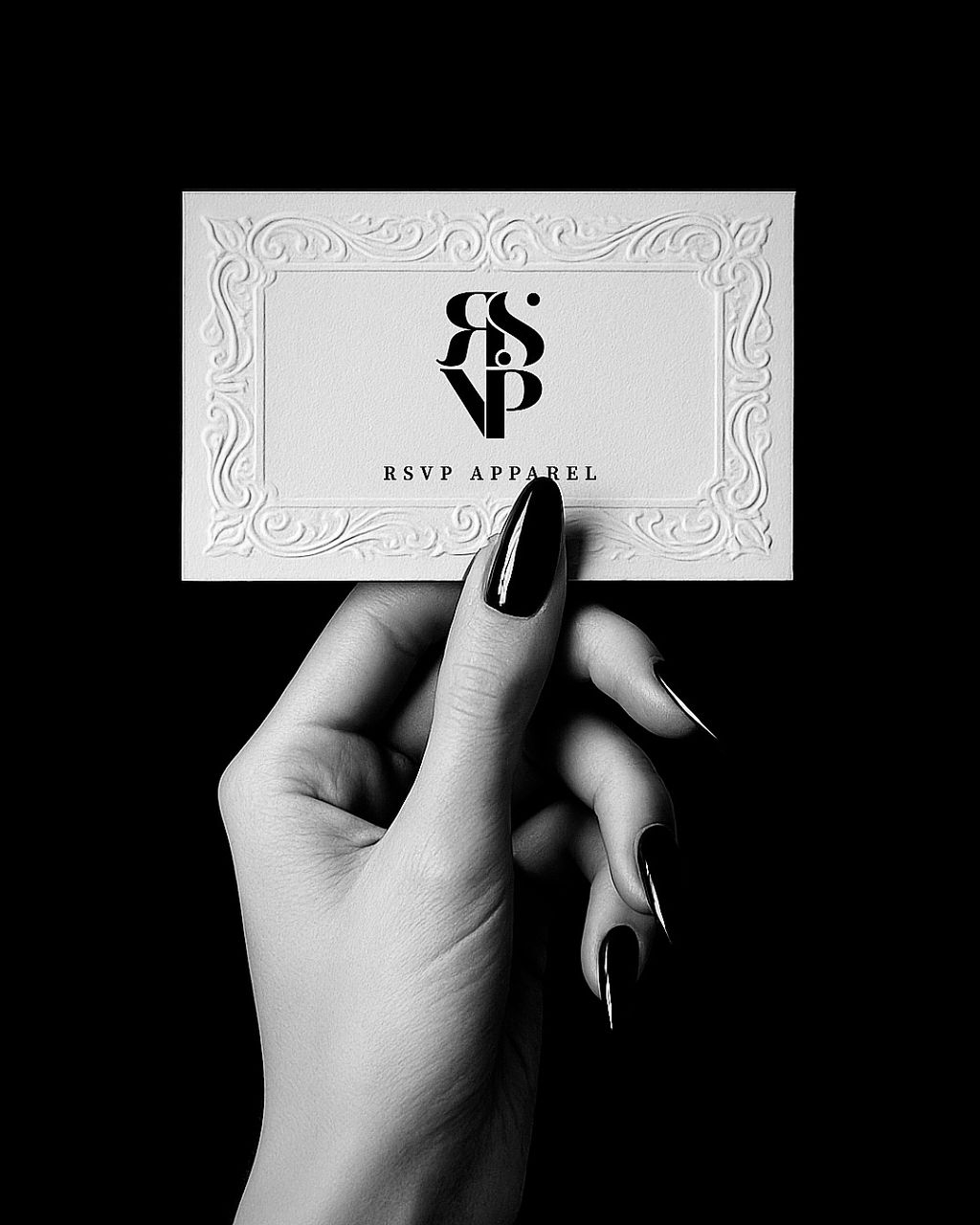 Hand holding a card with 'RSVP Apparel' logo against a black background