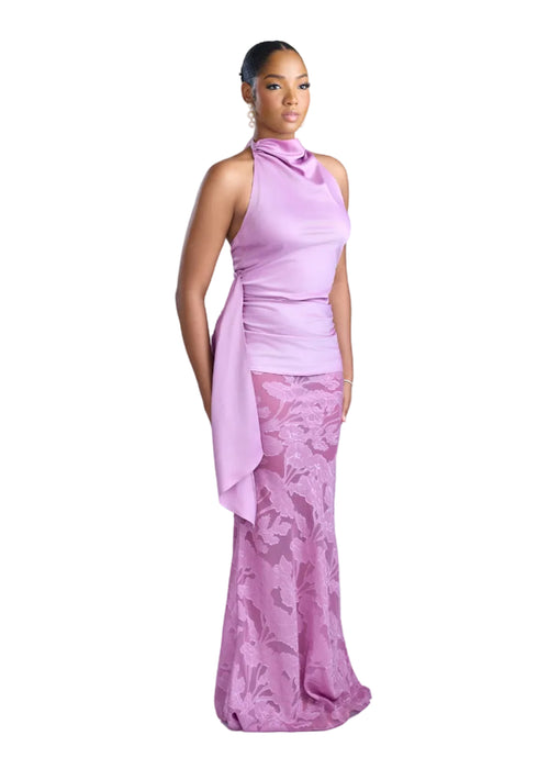 Woman wearing a pink dress with a floral pattern on a light background