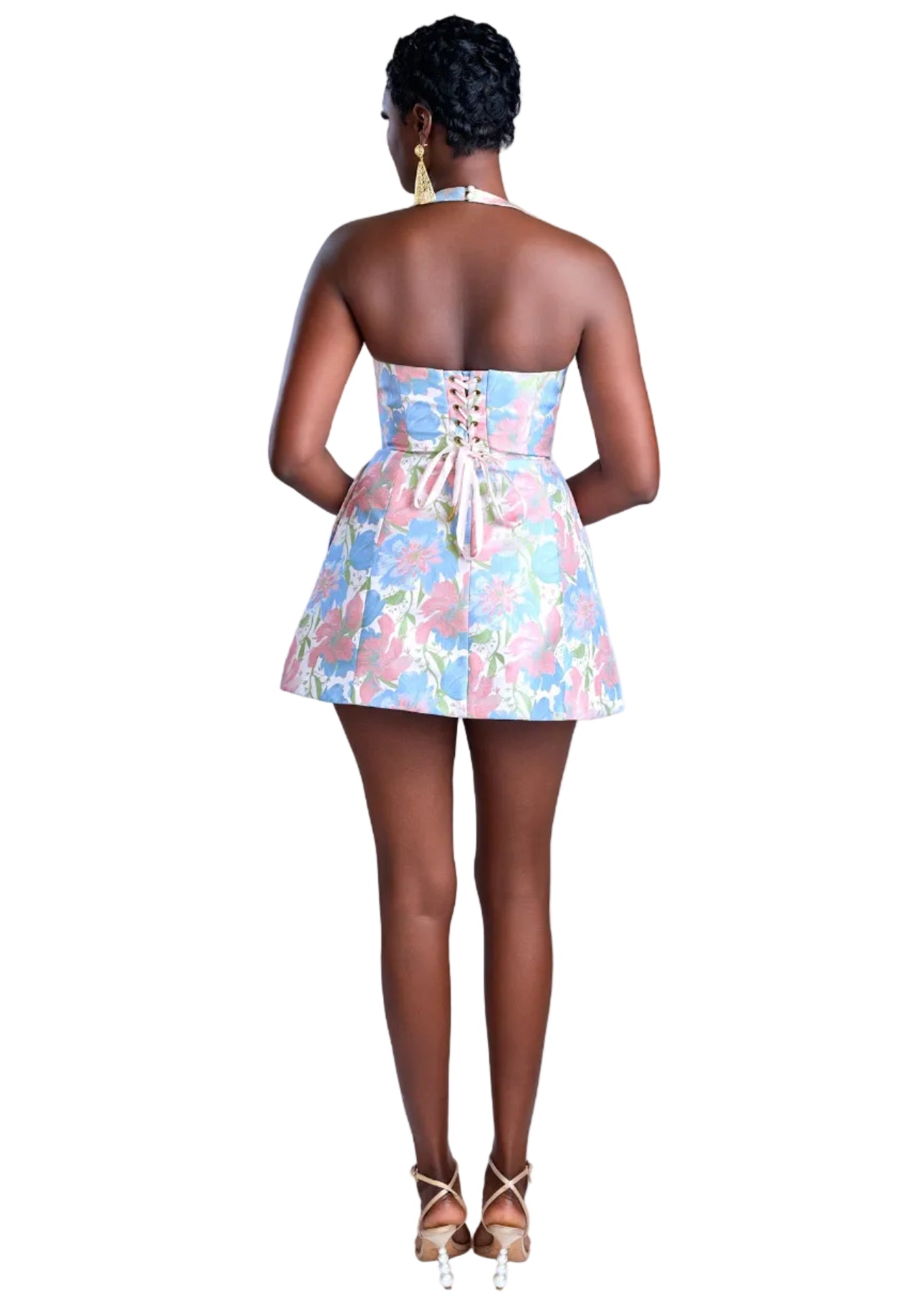 Woman wearing a colorful floral dress on a light background