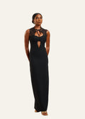 Woman wearing a black evening gown with lace details on a white background