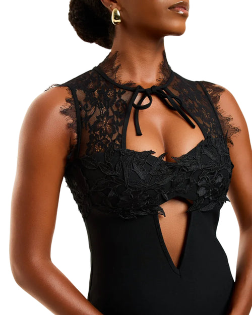 Black lace bodysuit worn by a model on a white background